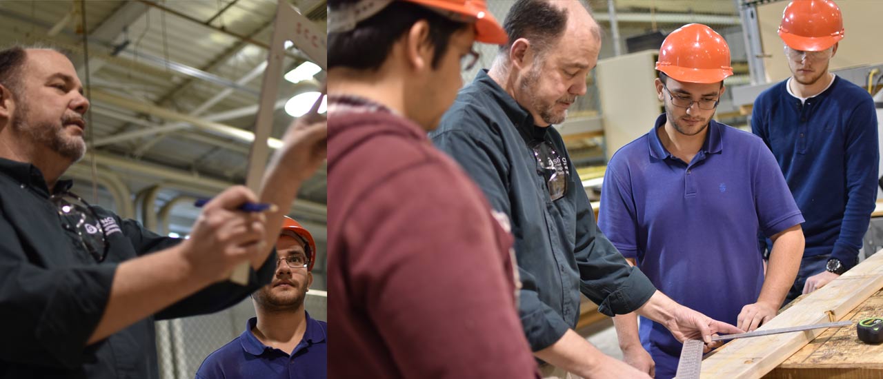 Students working with a professor on lumber cutting techniques
