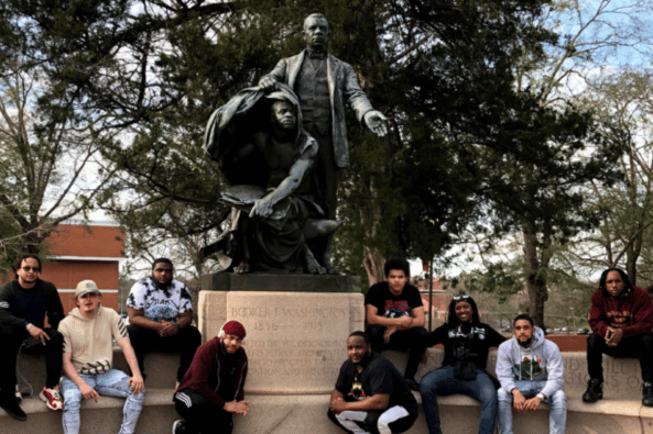 students gathered at historical statue