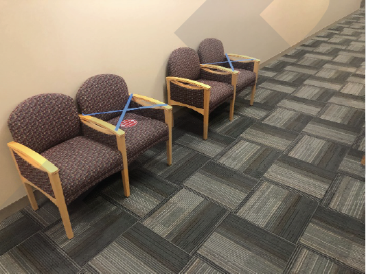 photo example of taping off alternative seats to maintain spacing in hallways