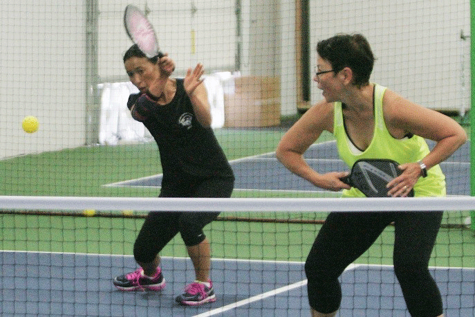 Two Women playing tennis 