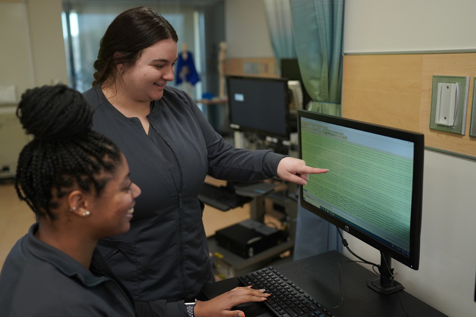 A student and instructor train on one of Sinclair's PCATD flight training devices.