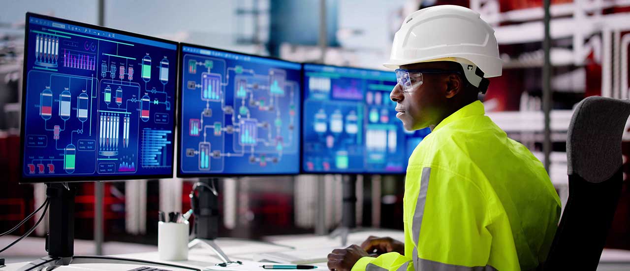 Student working with industrial automation equipment