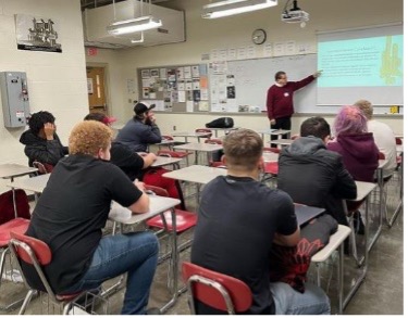 Professor teaching students durning a course 