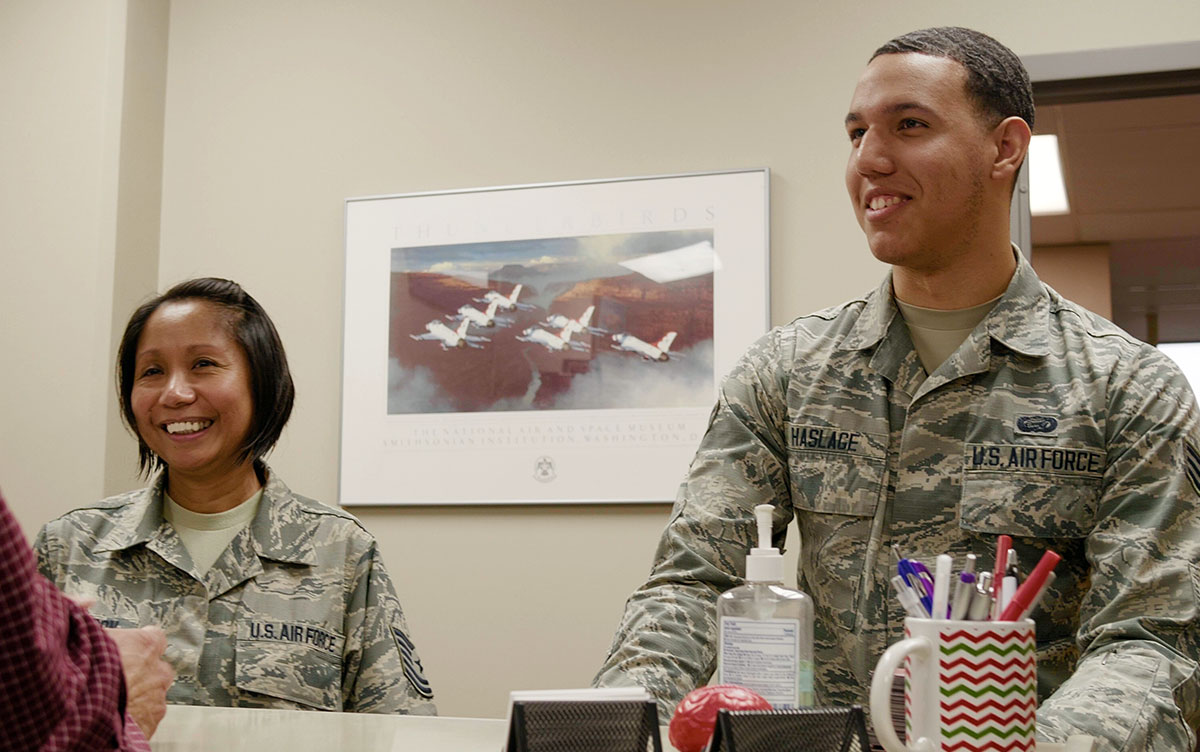 Two Service Members standing at Military Family Education Center Front Desk